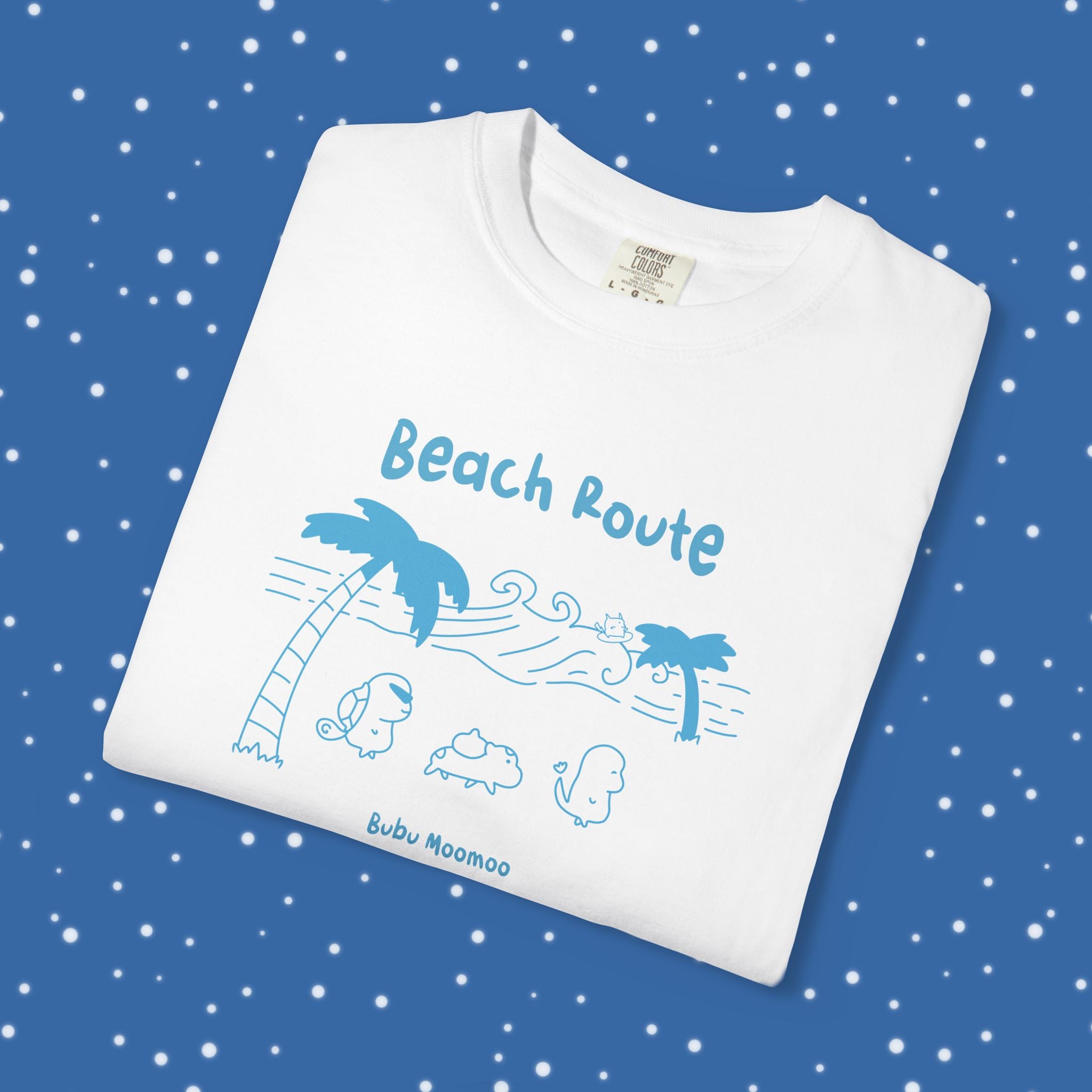 Folded white t-shirt with blue 'Beach Route' design on a blue background 