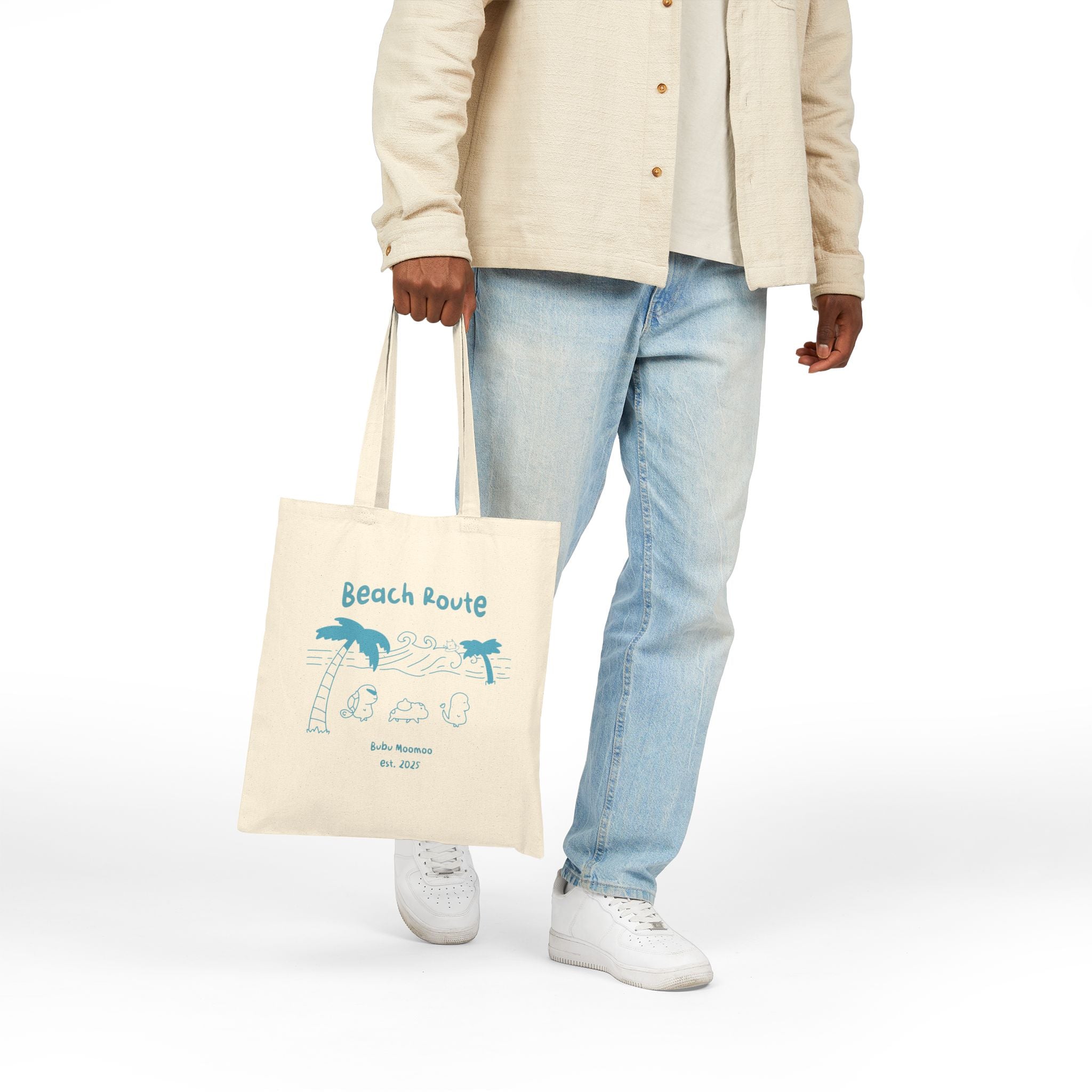 Person holding a tote bag with 'Beach Route' design on a white background