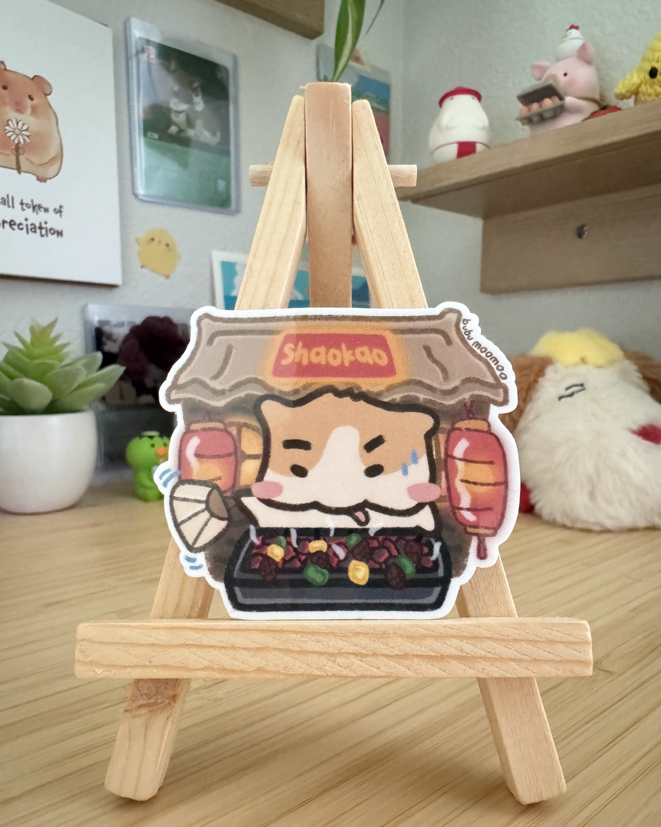 Small wooden easel with a cartoon character sticker of a dog on a wooden desk.